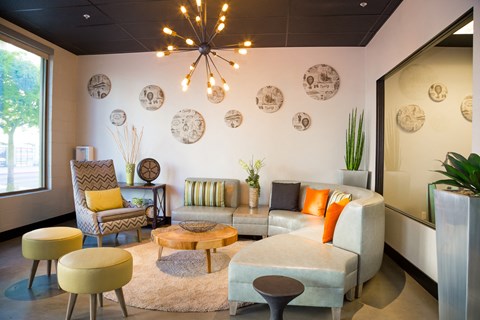 a living room with couches and chairs and a chandelier